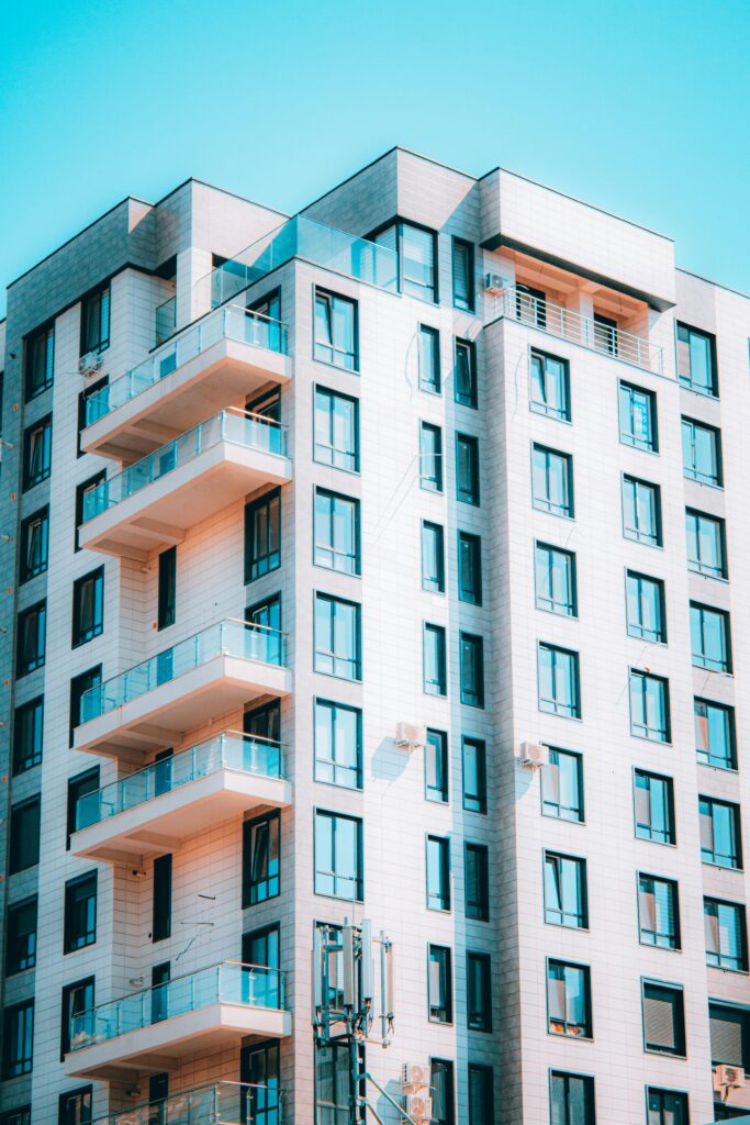 Stunning modern high-rise building with glass balconies and concrete facade.