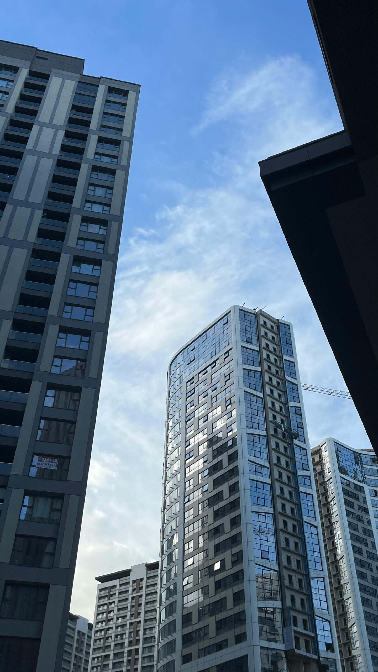Contemporary city skyscrapers with a clear blue sky backdrop.
